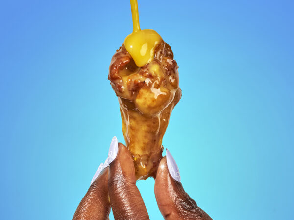 chicken wing with sauce dripping onto it