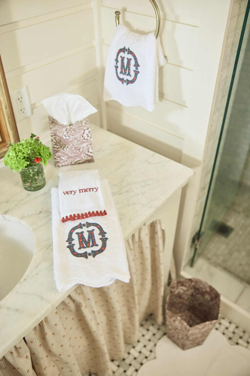White scalloped hand towels with red and green embroidered monogram