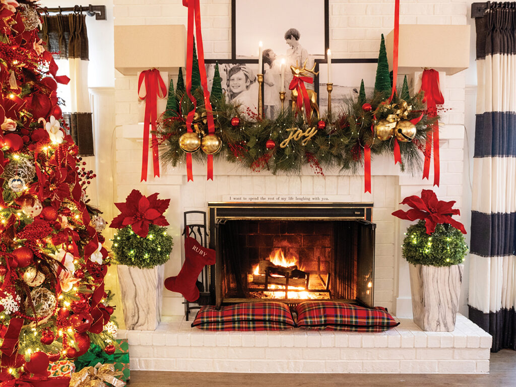 A white painted fireplace with Christmas decor on the mantle