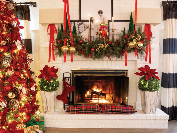 A white painted fireplace with Christmas decor on the mantle