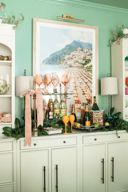 A seafoam green sitting room with a stocked bar