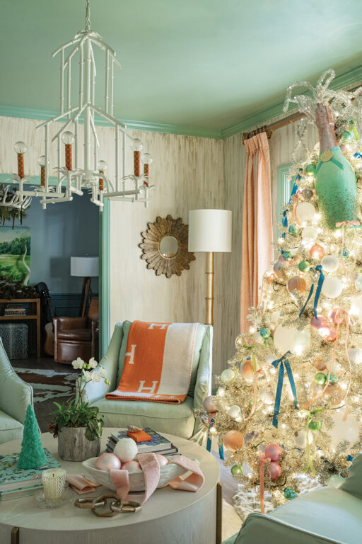 A seafoam green living room with a white Christmas tree