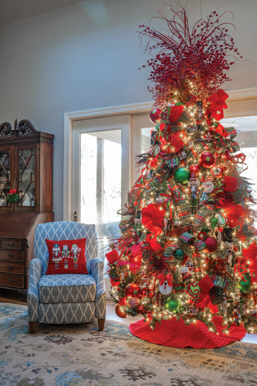 A Christmas tree decorated with red and green plaid bows and ornaments
