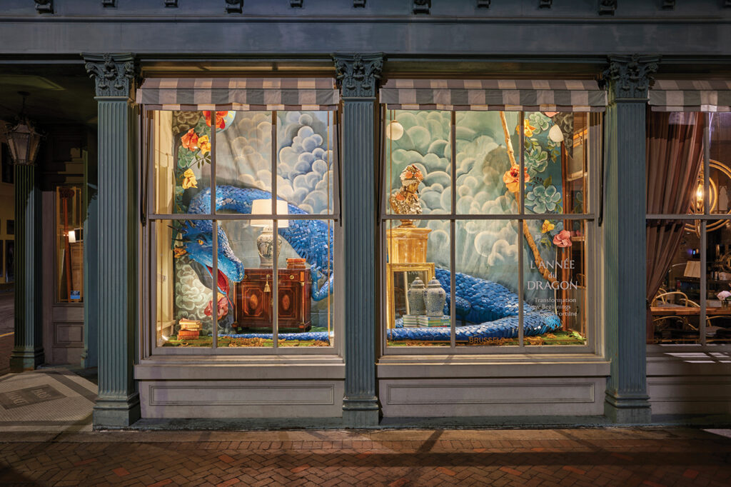 A fanciful window display of a blue dragon
