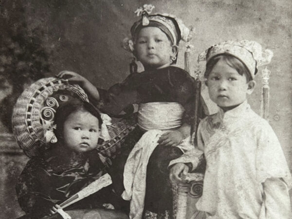 Three Chinese boys in traditional clothing