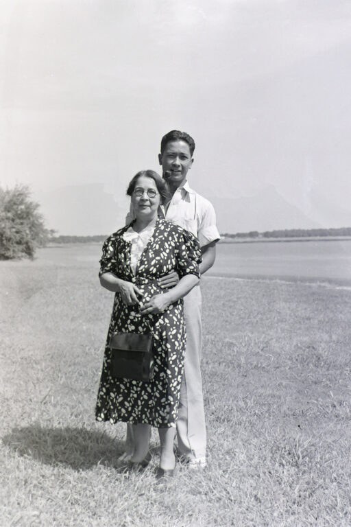 A man and woman standing in an open field