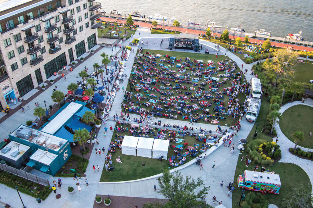 Aerial view of a park full of people next to a river