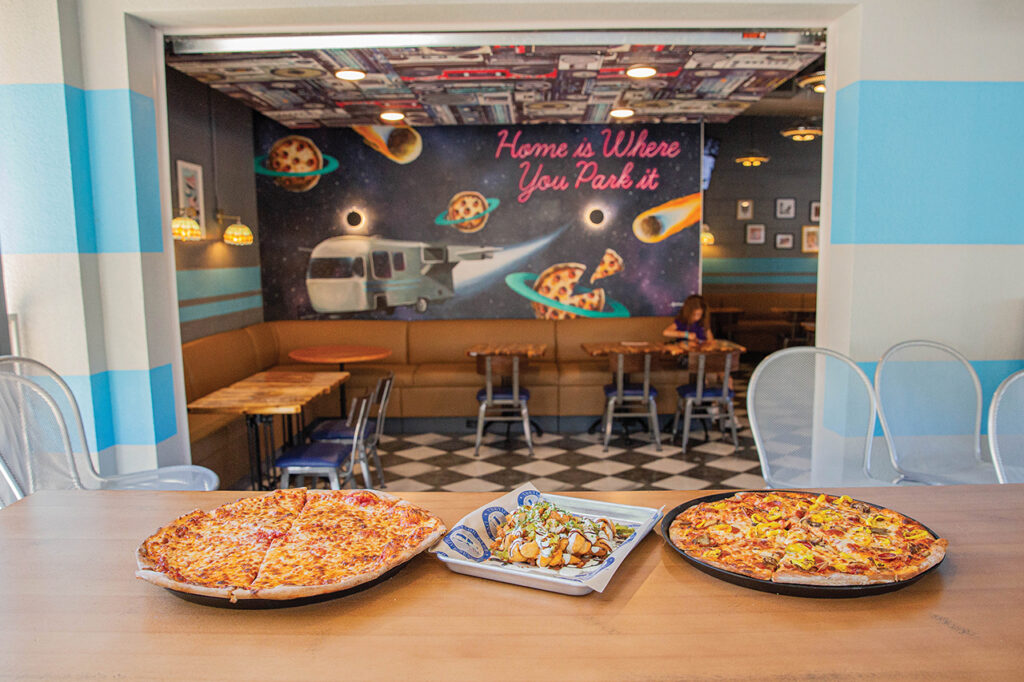 Pizzas sitting on a table in a restaurant