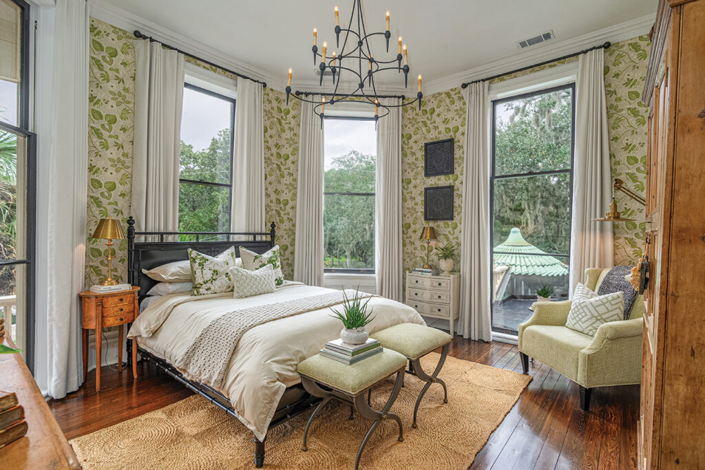 Bedroom with light green leaf motif wallpaper and natural rug