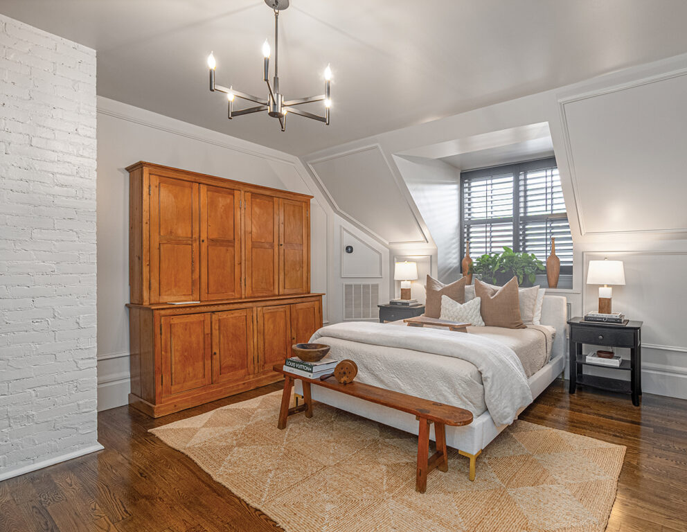 Loft bedroom with exposed brick and wood floor