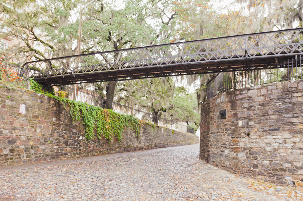 Iron foot bridge over cobblestone street