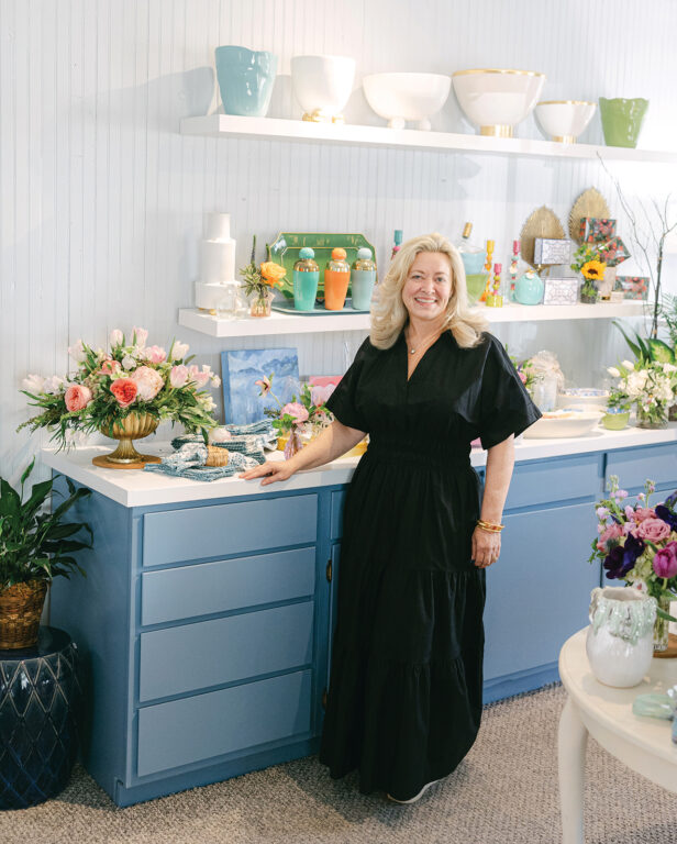 Woman smiling and standing in a boutique