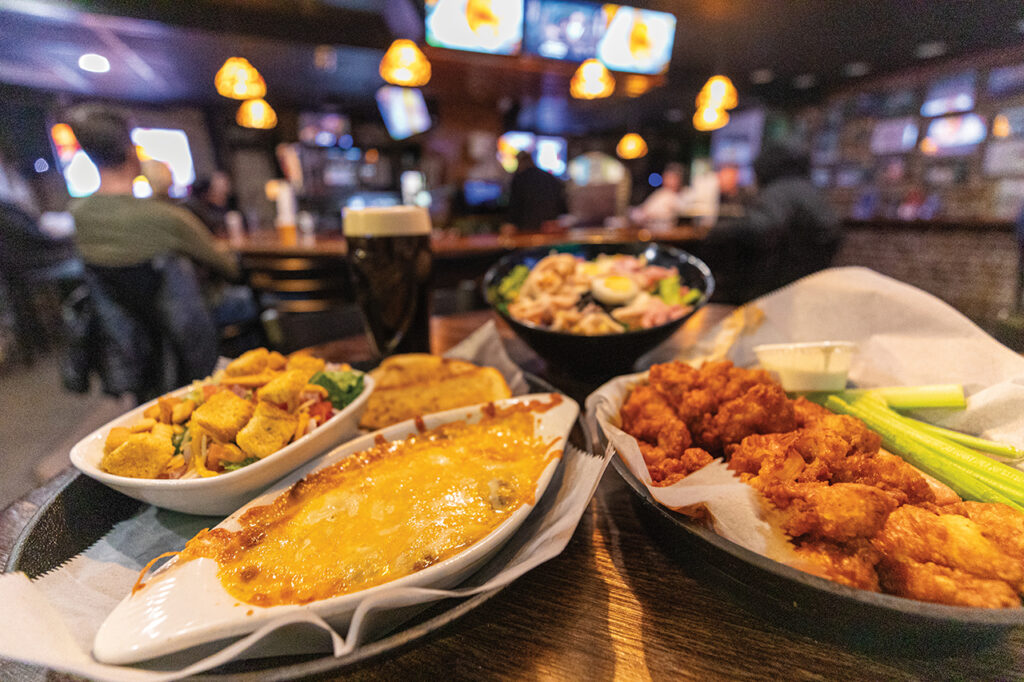 A basket of wings and other pub food on a table