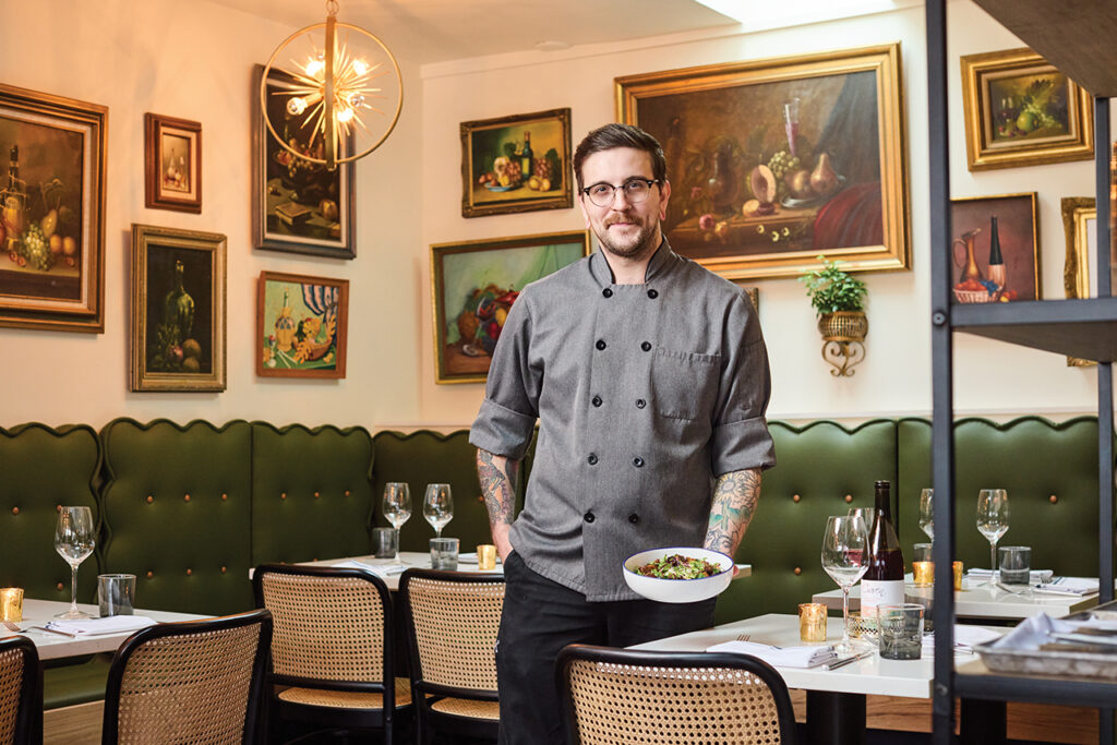 Chef holding a dinner plate of food