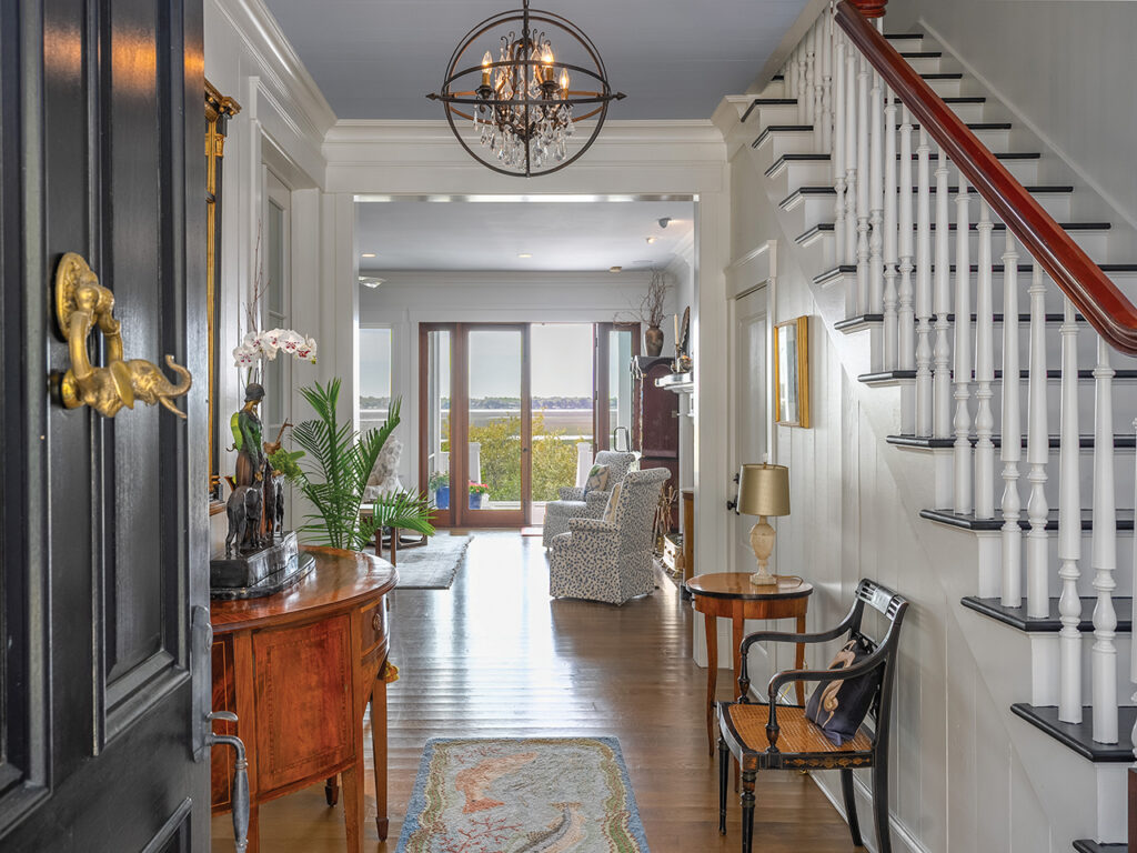 A foyer with an elephant door knocker and a staircase to the right