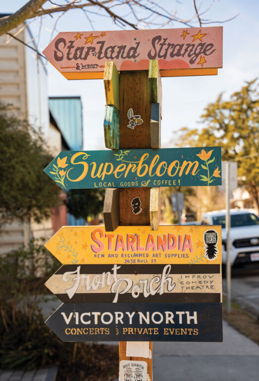 Sign post with arrows pointing to different shops and restaurants