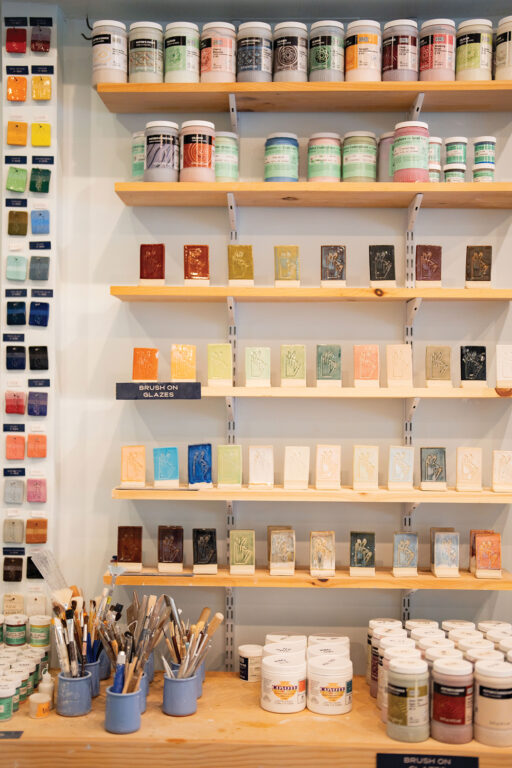 shelves full of paint and pottery samples