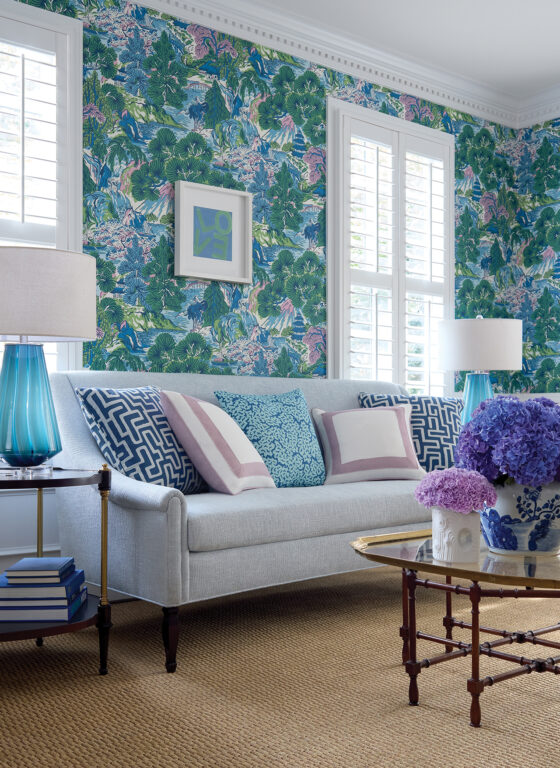 living room with colorful green, blue, and pink floral wallpaper