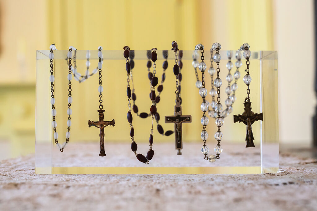 rosaries hanging from a display