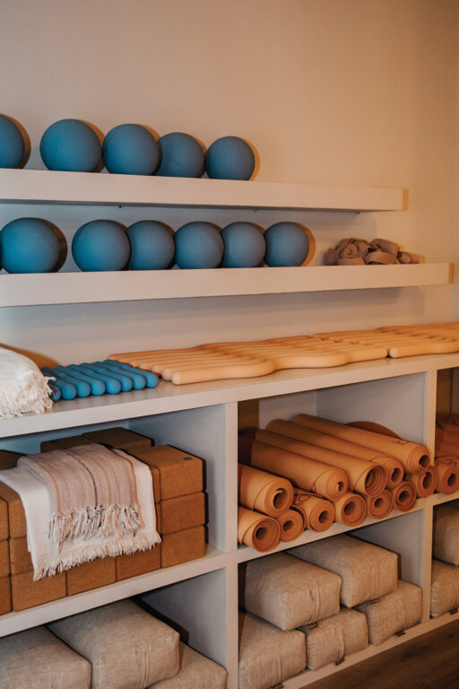 Pilates and yoga equipment on storage shelves