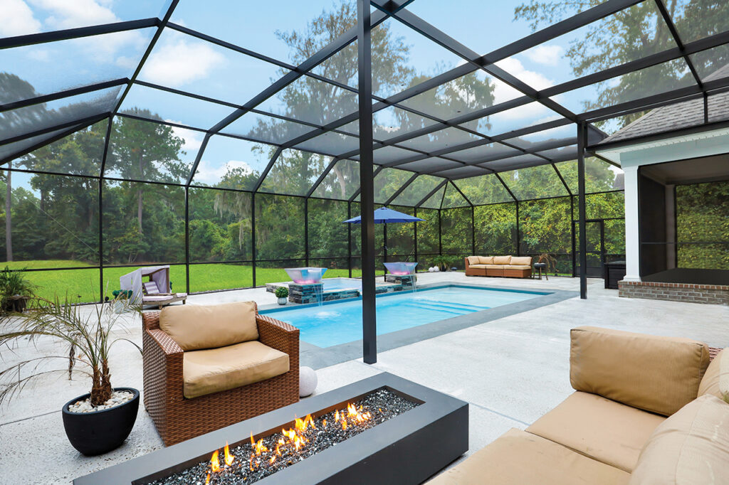 Screened-in patio with pool, fire pit, and luxurious outdoor furniture