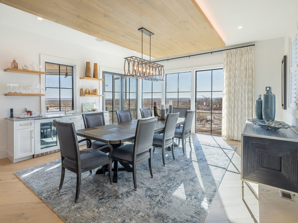 Dining room with table that seats eight, a wet bar, and a view of the marsh