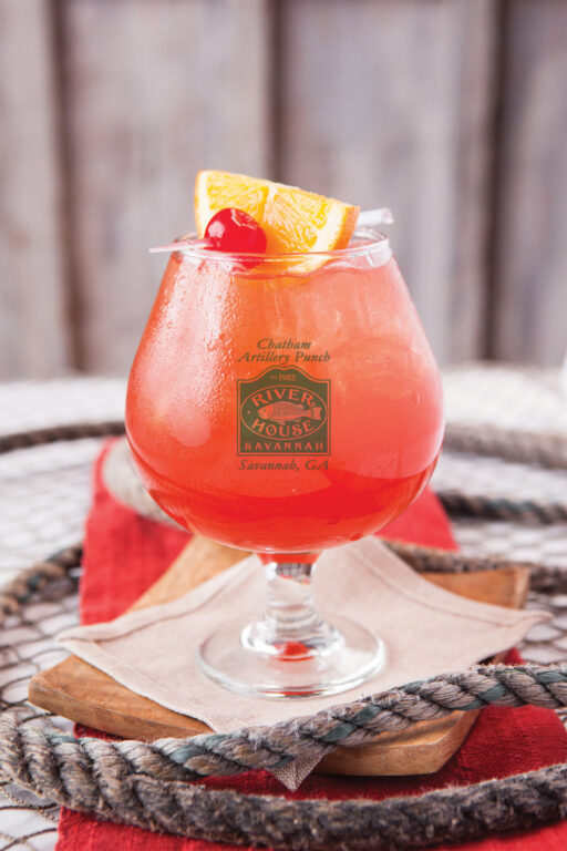 Chatham Artillery Punch with a cherry and orange garnish