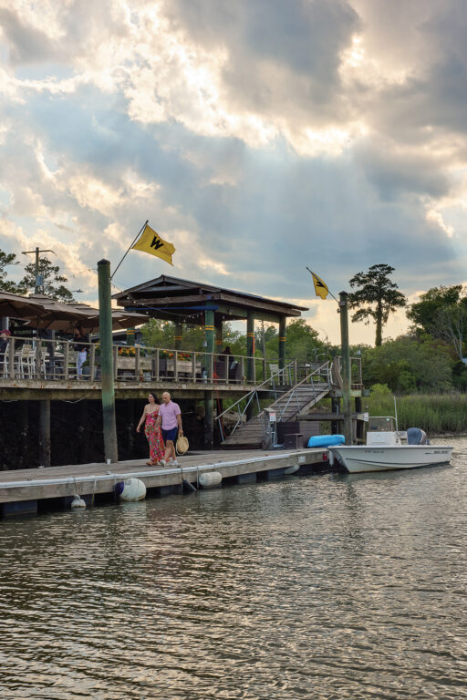 A couple walking on a boat dock