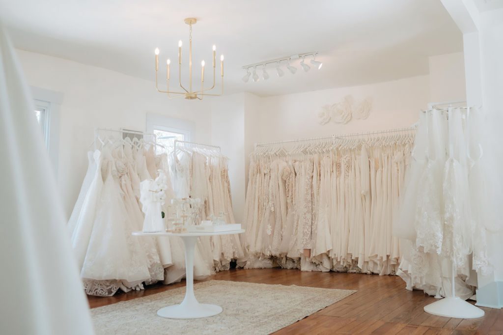 Racks of wedding dresses in a bridal boutique
