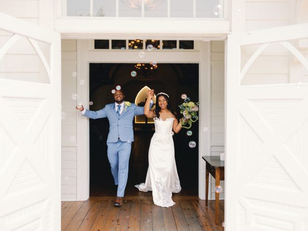 A young Black couple exiting a church after just getting married