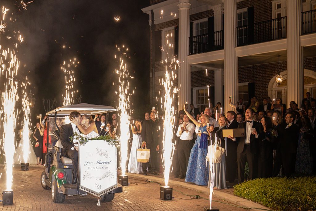 Newlyweds leaving their reception in a golf cart