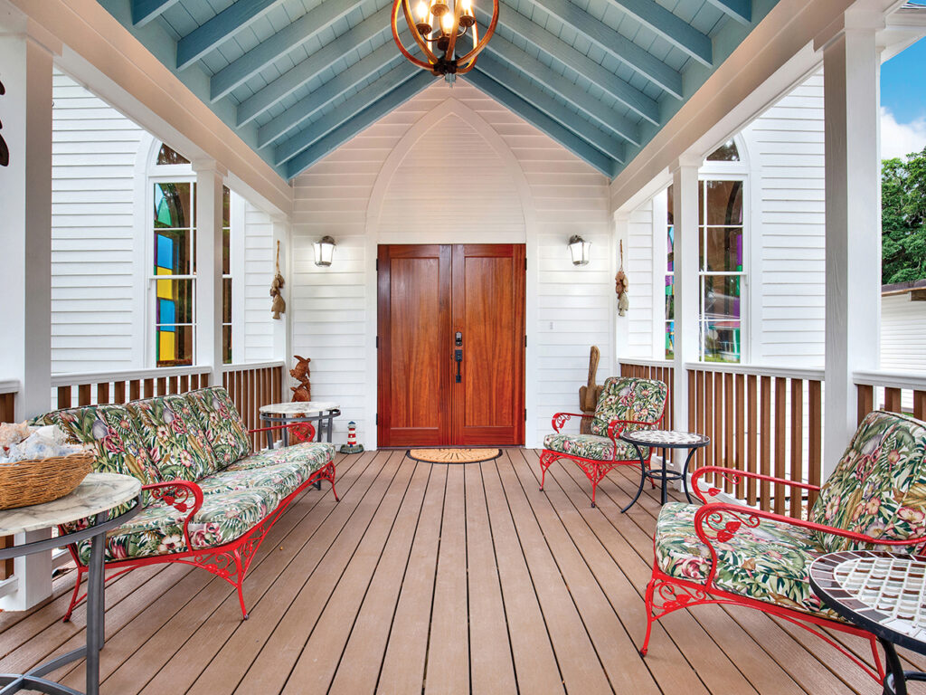 Front porch with haint blue ceiling of a home on Thunderbolt that used to be a church