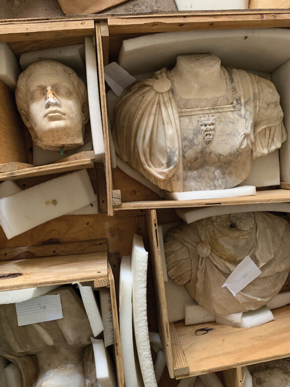 statue pieces in storage crates