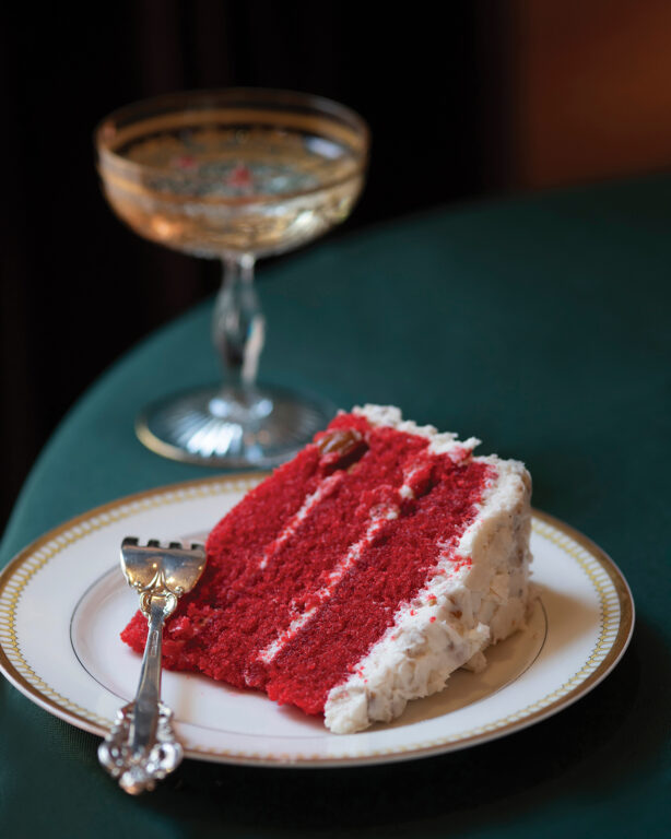 A slice of red velvet cake with cream cheese frosting