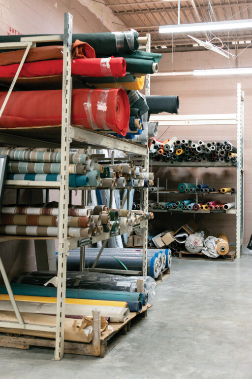 bolts of fabric stacked on metal storage racks