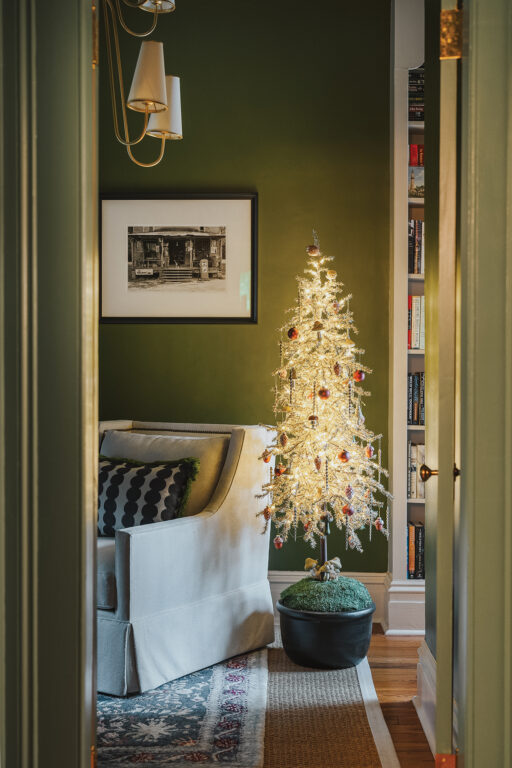 a woodland-themed Christmas tree in the library of a historic home
