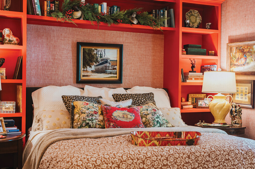 A bed surrounded by a red bookshelf