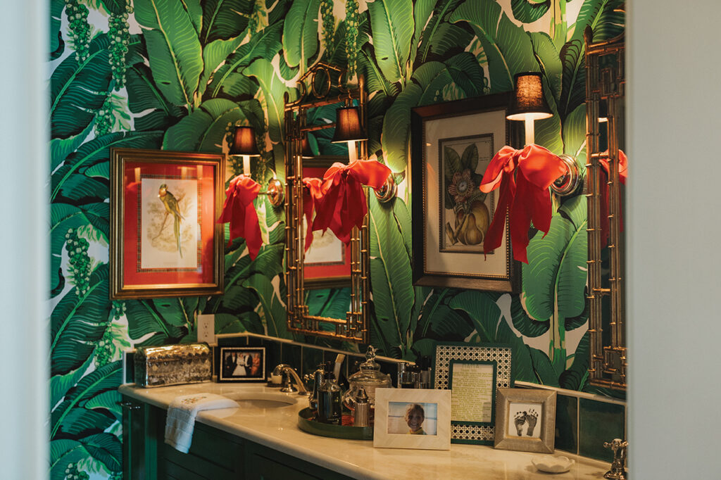 A bathroom with green banana leaf wallpapers