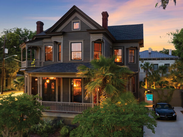 the front exterior of a Victorian home at night