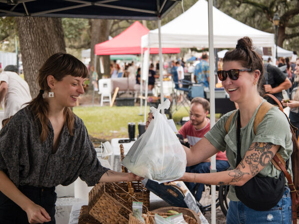 A woman shops at the Billy's Botanicals booth at Forsyth Farmers' Market.