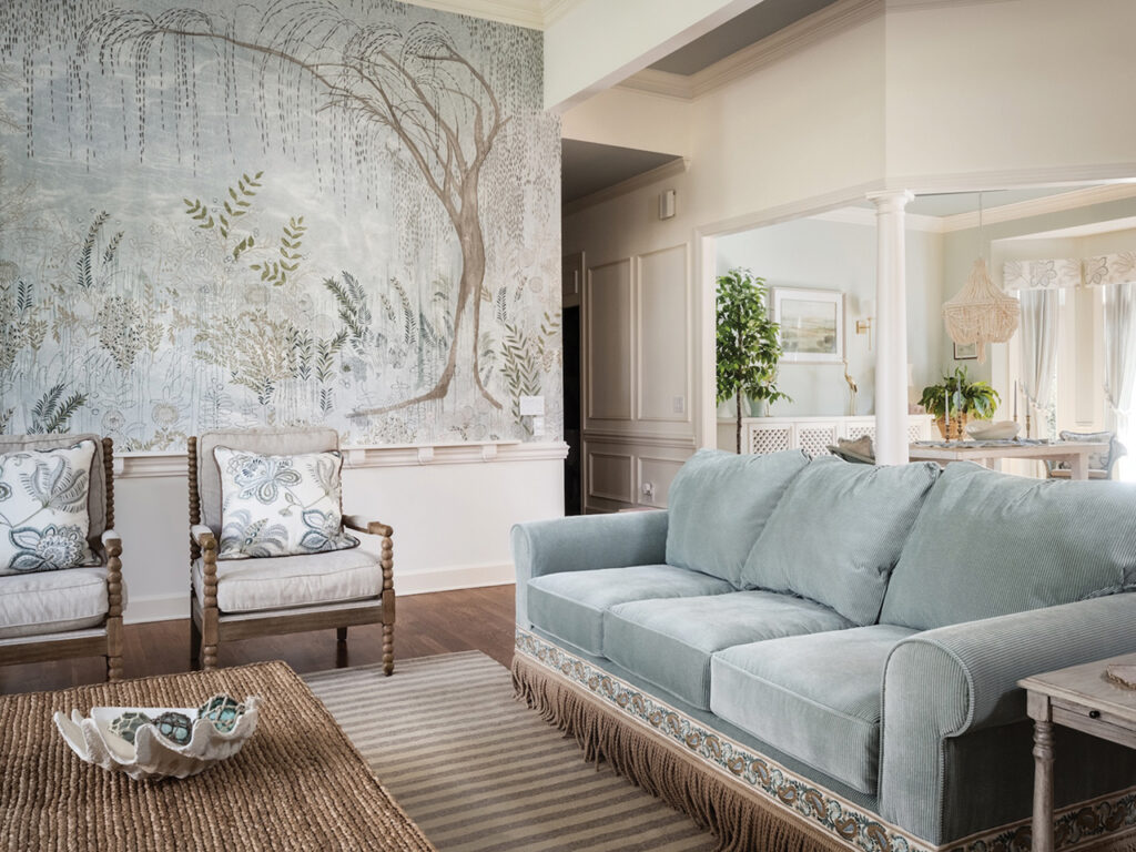 living room with neutral colors and a large mural on one wall