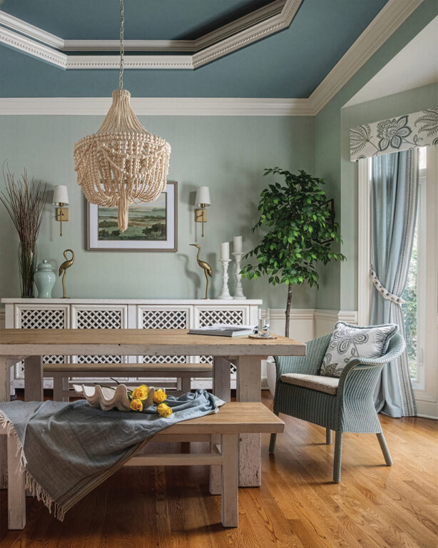 dining room with a teal ceiling, light turquoise walls and natural wood dining table and benches