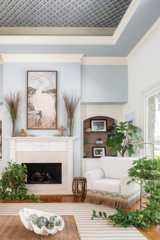 living room with neutral colors and a white fireplace mantel