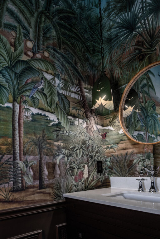 a powder room with jungle-themed wallpaper