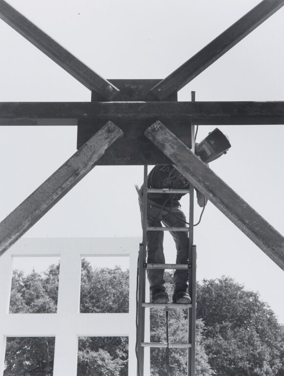 Man welding during construction of the Jepson Center