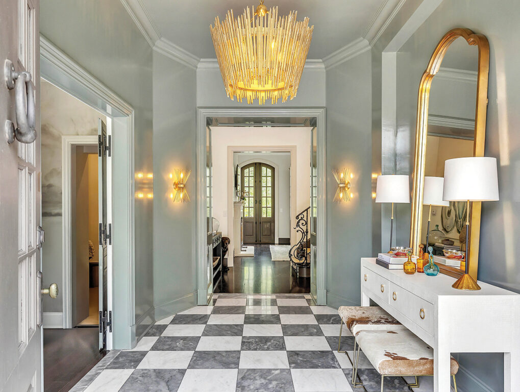 Glossy green walls and classic gray-and-white checkerboard marble floors in the entryway