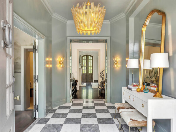 Glossy green walls and classic gray-and-white checkerboard marble floors in the entryway