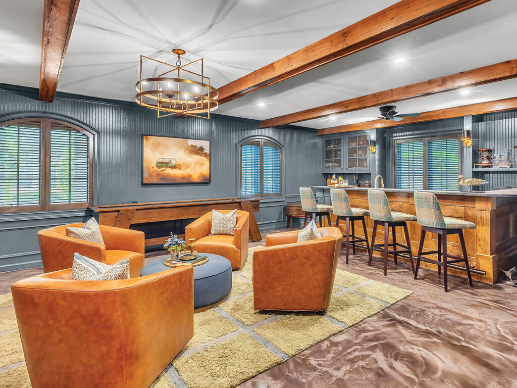 A man cave with leather chairs and a bar