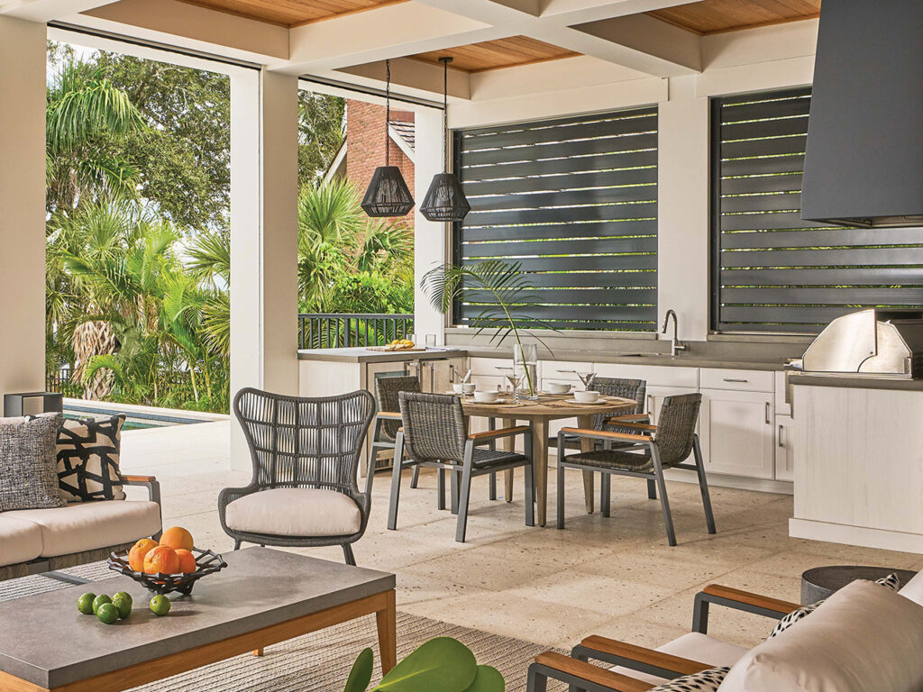 An outdoor dining and kitchen area by Broad Street Interiors