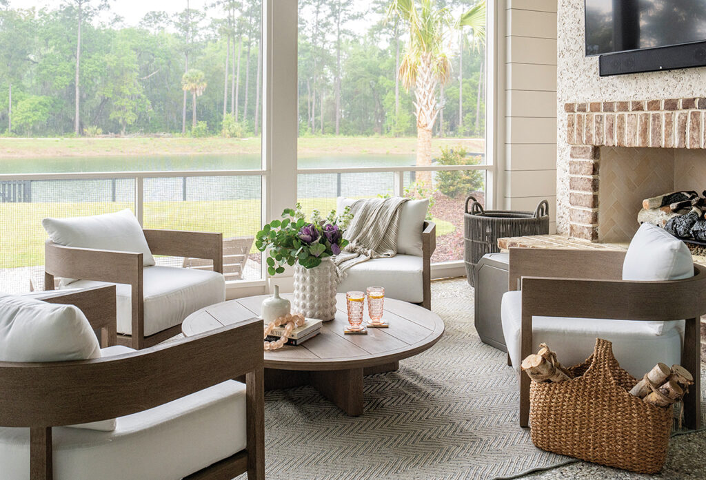 A seating area in front of a fireplace on an enclosed patio